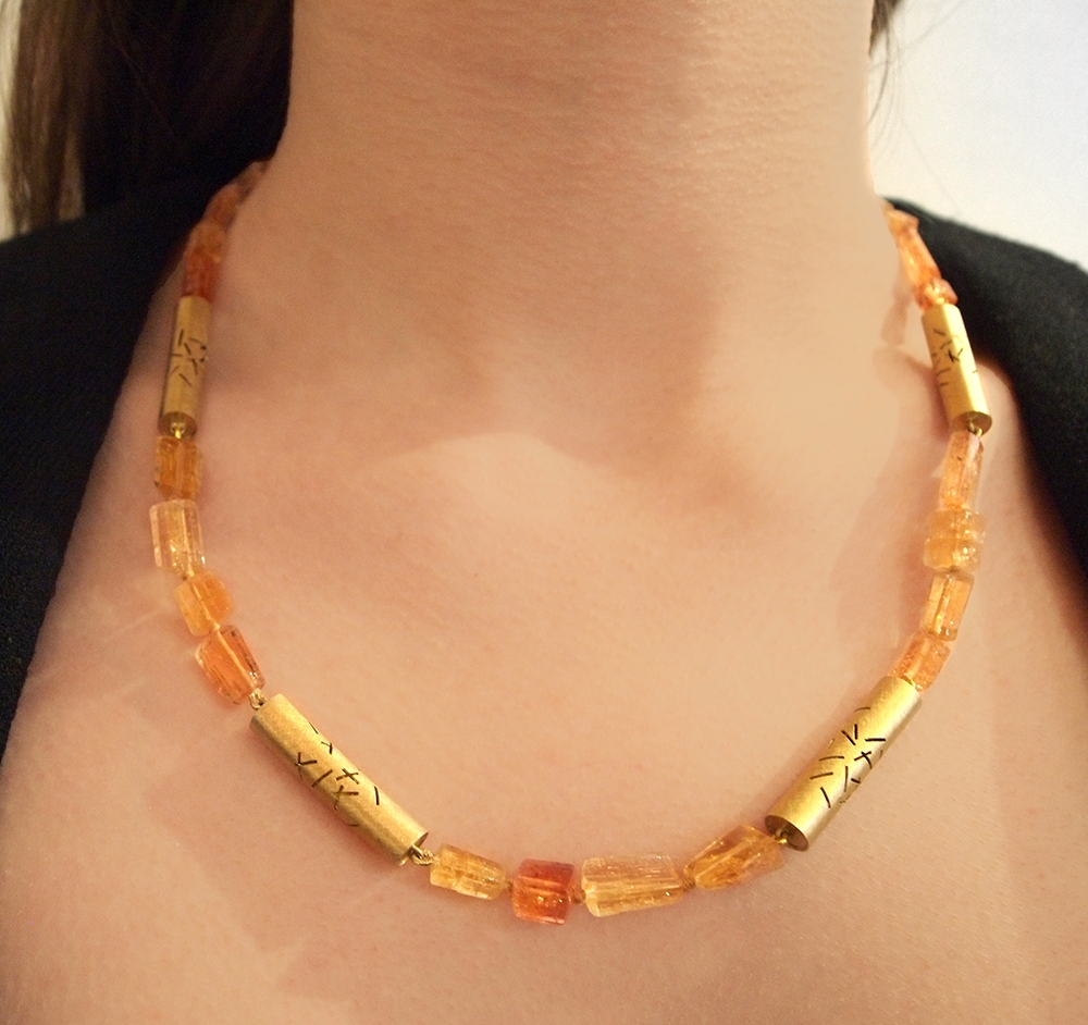 ONeillL_Necklace_ImperialTopazWithFive18KYellowStitchSections_Worn_w.jpg ONeillL_Necklace_ImperialTopazWithFive18KYellowStitchSections_Worn_w.jpg